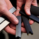 A researcher holding various vape pens.